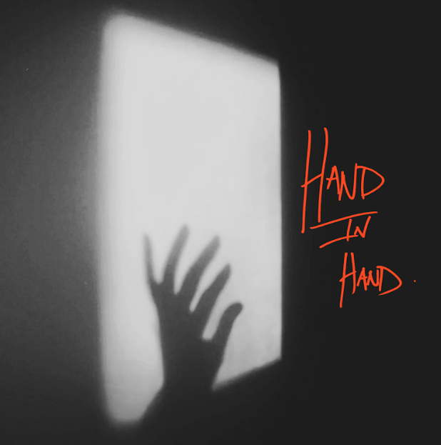 a shadow of a hand in a square of light on a black background, with hand in hand written in like digital pen in red
