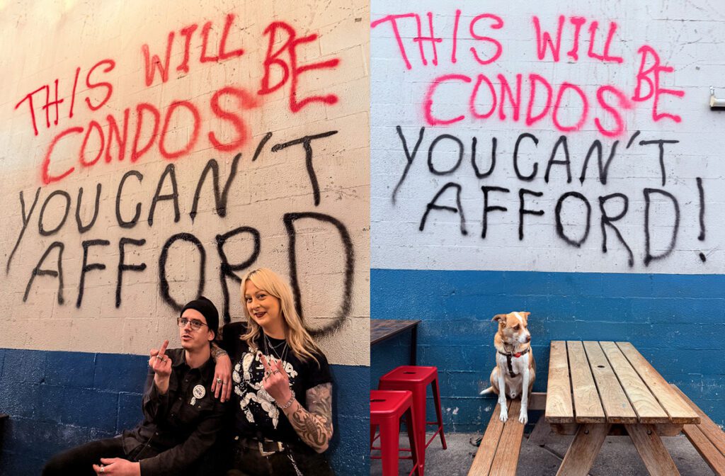 Graffiti inside Thee Parkside that says "This will soon be condos you can't afford" with two staff members and a dog sitting in front of it.