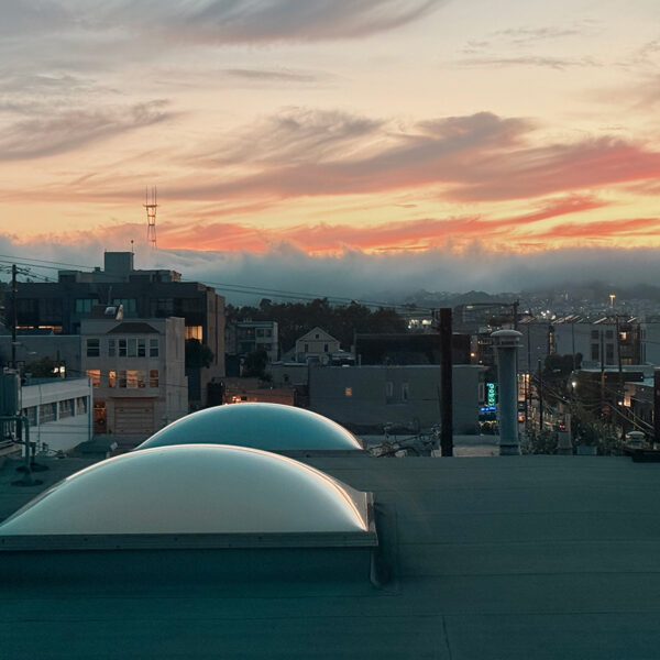 Potrero Hill in San Francisco. Roof top with fog rolling in and Bottom of the Hill neon sign in the distance.