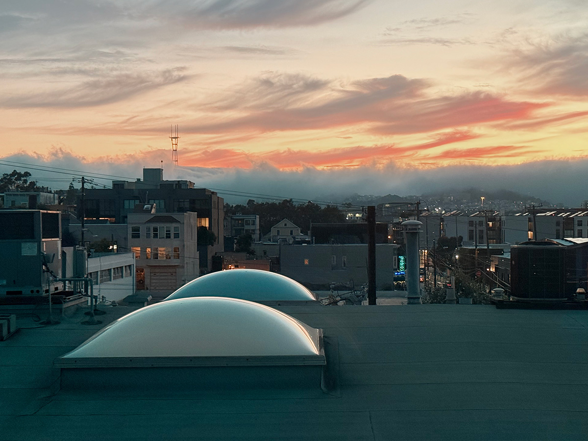 Potrero Hill in San Francisco. Roof top with fog rolling in and Bottom of the Hill neon sign in the distance.